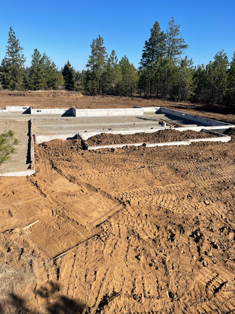 excavator digging residential basement in Spokane, Wa